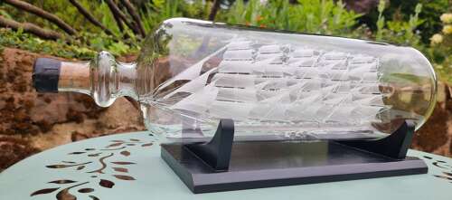 An exceptionally large hand blown glass model ship in a bottle.