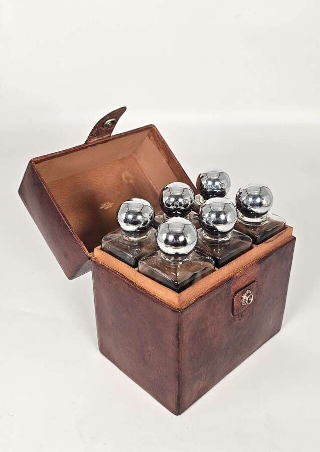 Six spirit decanter set in a leather fitted case used for hunting or shooting, circa 1920