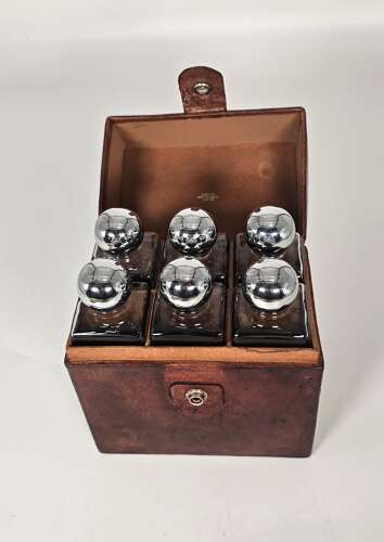 Six spirit decanter set in a leather fitted case used for hunting or shooting, circa 1920