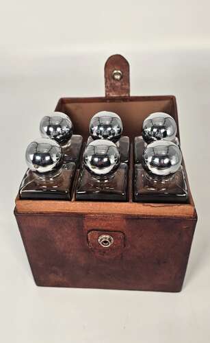 Six spirit decanter set in a leather fitted case used for hunting or shooting, circa 1920