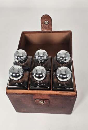 Six spirit decanter set in a leather fitted case used for hunting or shooting, circa 1920