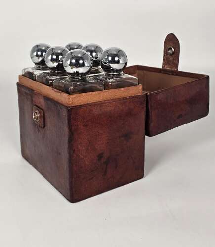 Six spirit decanter set in a leather fitted case used for hunting or shooting, circa 1920