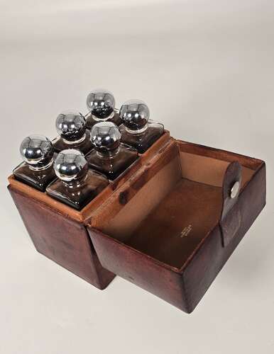 Six spirit decanter set in a leather fitted case used for hunting or shooting, circa 1920