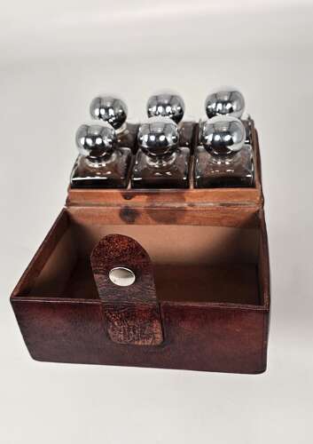 Six spirit decanter set in a leather fitted case used for hunting or shooting, circa 1920