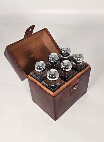 Six spirit decanter set in a leather fitted case used for hunting or shooting, circa 1920
