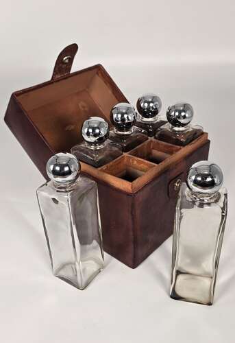 Six spirit decanter set in a leather fitted case used for hunting or shooting, circa 1920