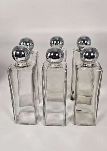 Six spirit decanter set in a leather fitted case used for hunting or shooting, circa 1920
