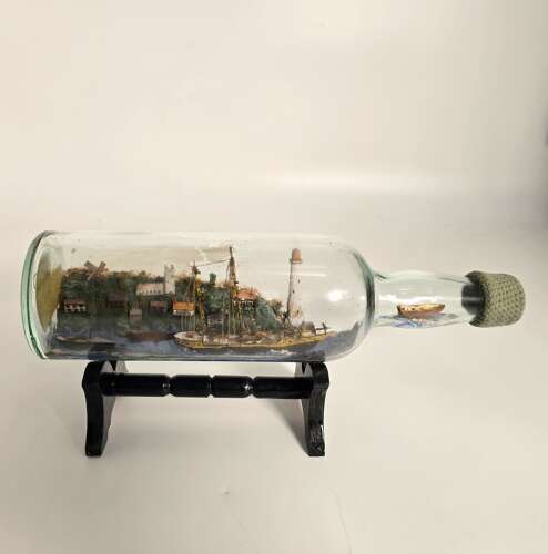 A folk art ship in a bottle diorama dated 1922