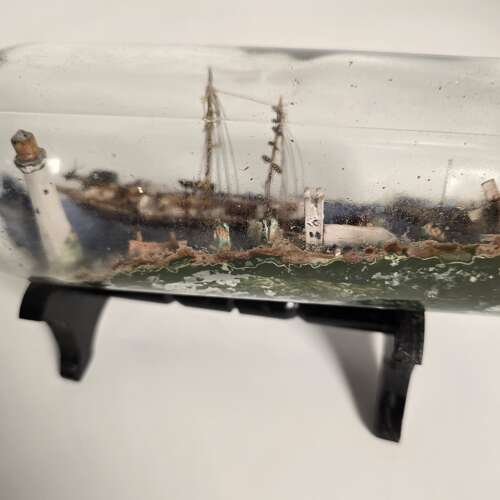 A folk art ship in a bottle diorama dated 1922