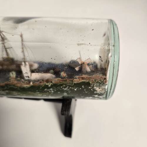 A folk art ship in a bottle diorama dated 1922
