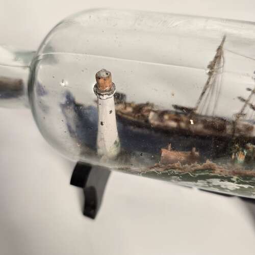 A folk art ship in a bottle diorama dated 1922