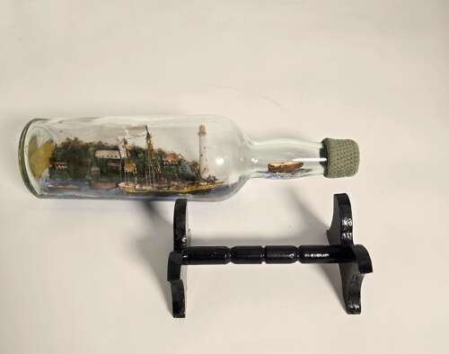 A folk art ship in a bottle diorama dated 1922