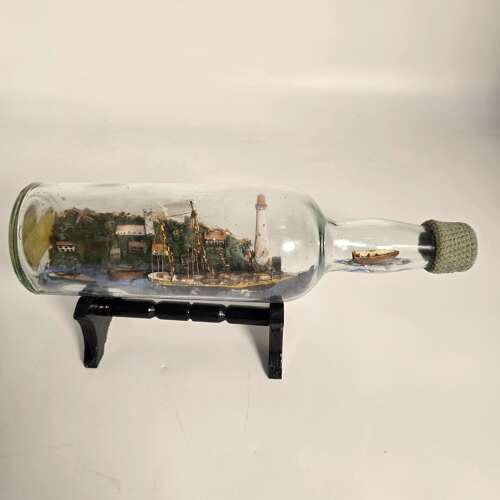 A folk art ship in a bottle diorama dated 1922