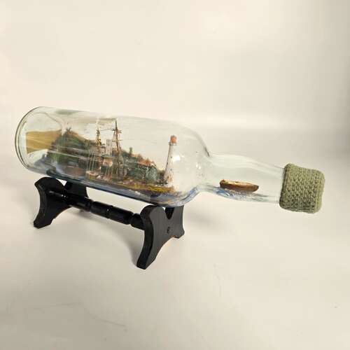 A folk art ship in a bottle diorama dated 1922