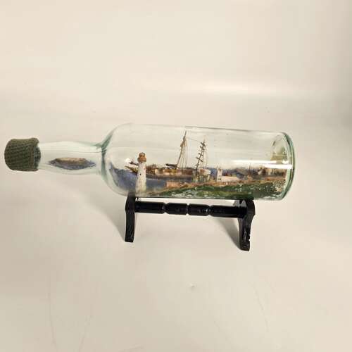 A folk art ship in a bottle diorama dated 1922