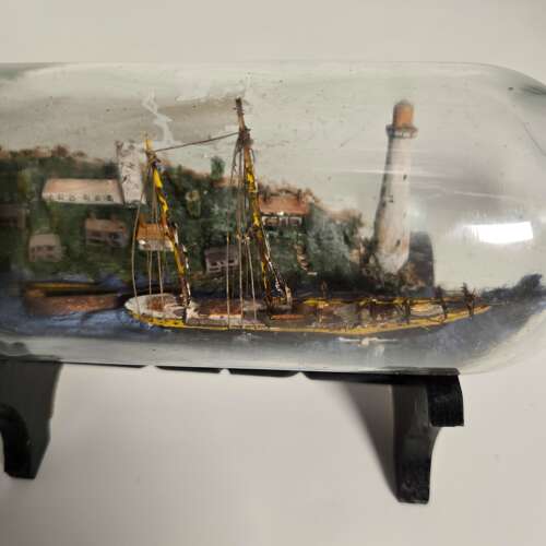 A folk art ship in a bottle diorama dated 1922