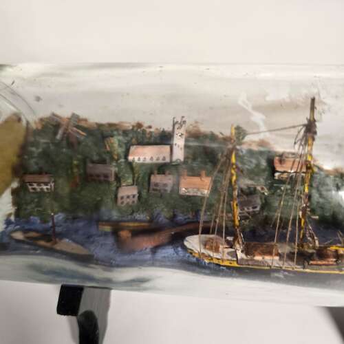 A folk art ship in a bottle diorama dated 1922
