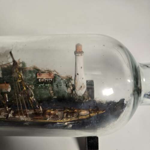 A folk art ship in a bottle diorama dated 1922