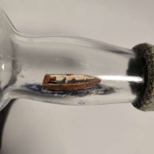 A folk art ship in a bottle diorama dated 1922